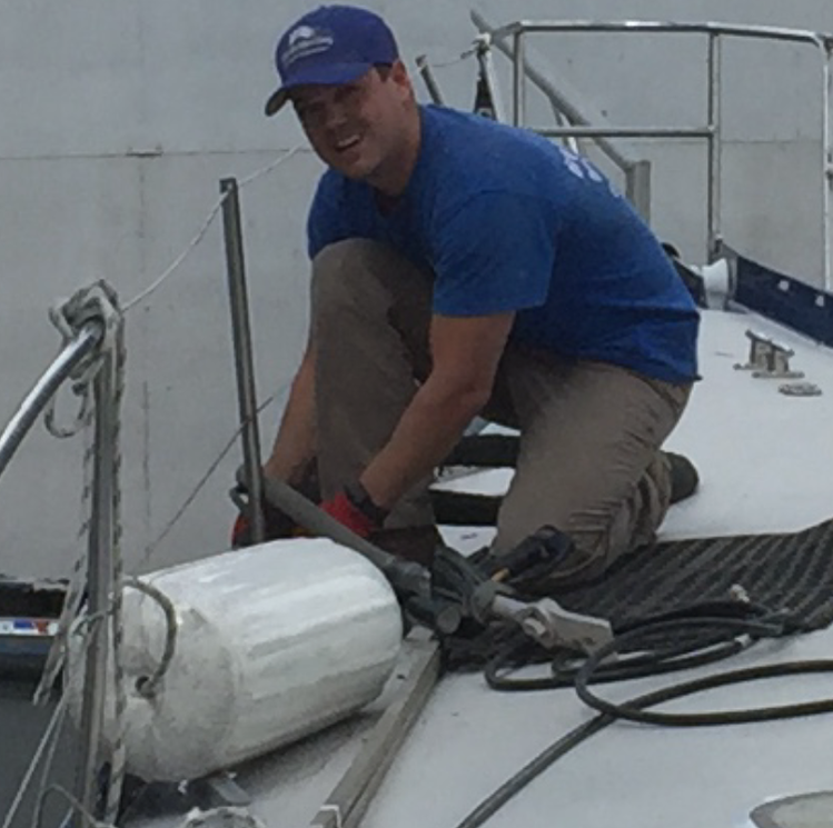 A man on the deck of a boat